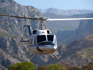 Bell Helicopter flying above a Canyon